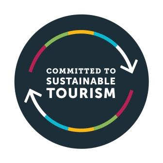 Circular logo with 'Committed to Sustainable Tourism' text and colored arrows.
